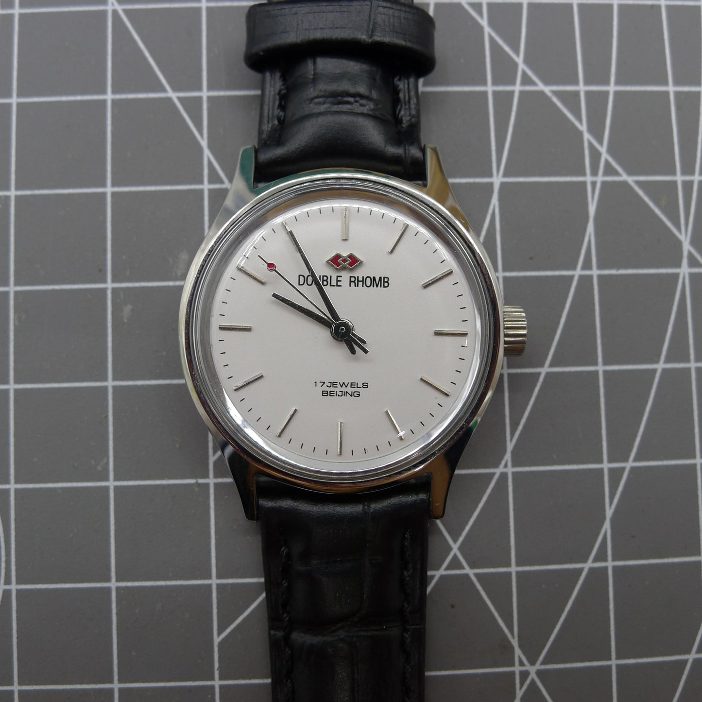 Beijing 31mm manual mechanical watch with silver case, double rhomb dial showcasing classic Chinese craftsmanship.
