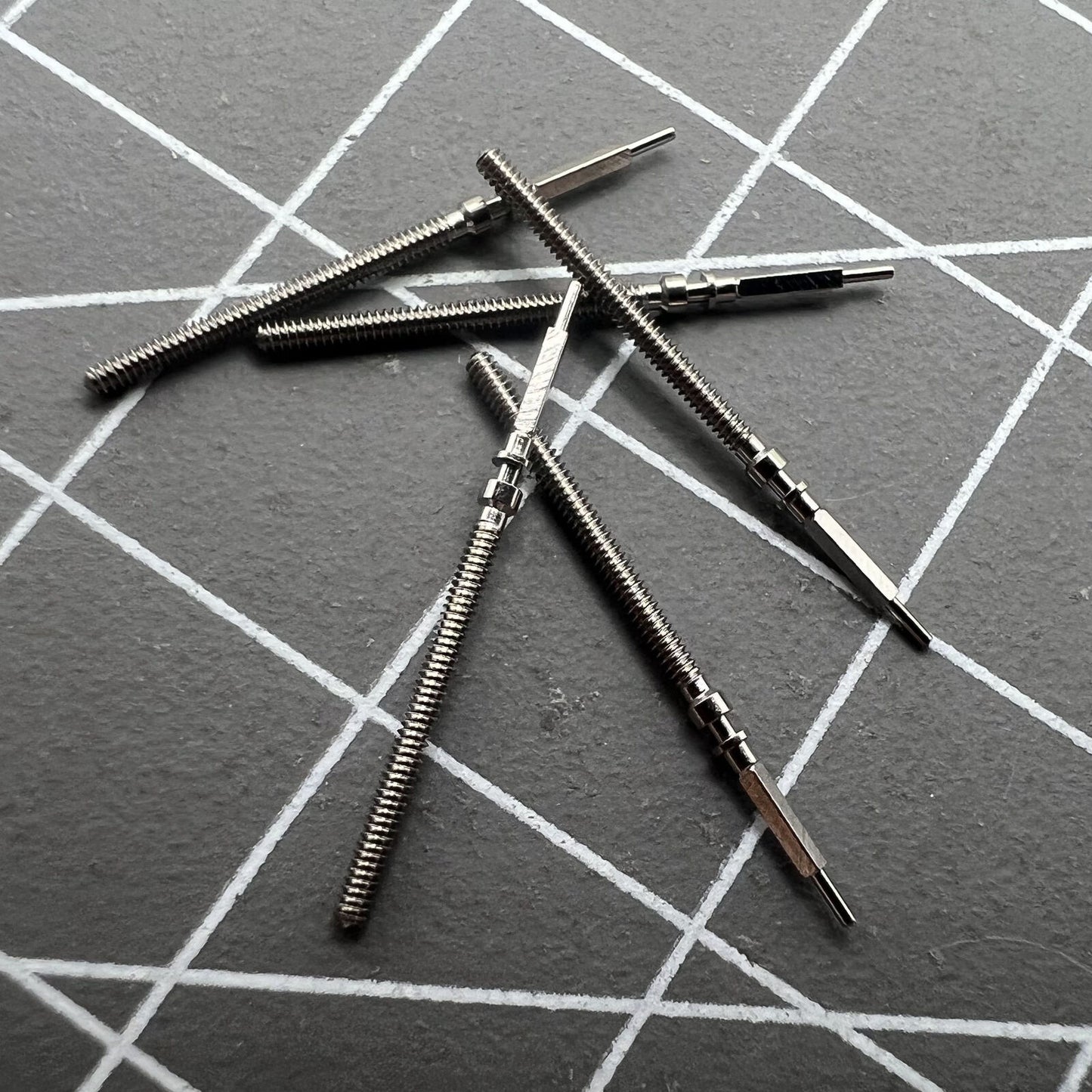 Precision watch winding stem for Omega 560 movement, high-quality replacement part for timekeeping repair.