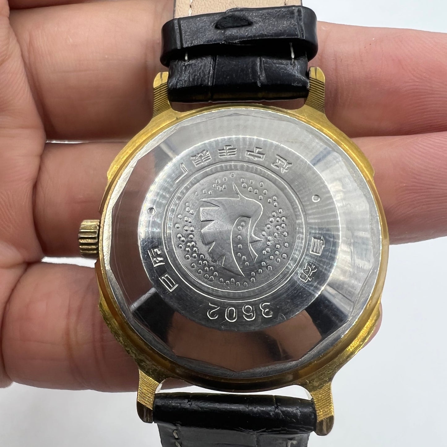 37mm automatic watch with black dial, gold Roman numerals, and 33 jewels for elegant style.