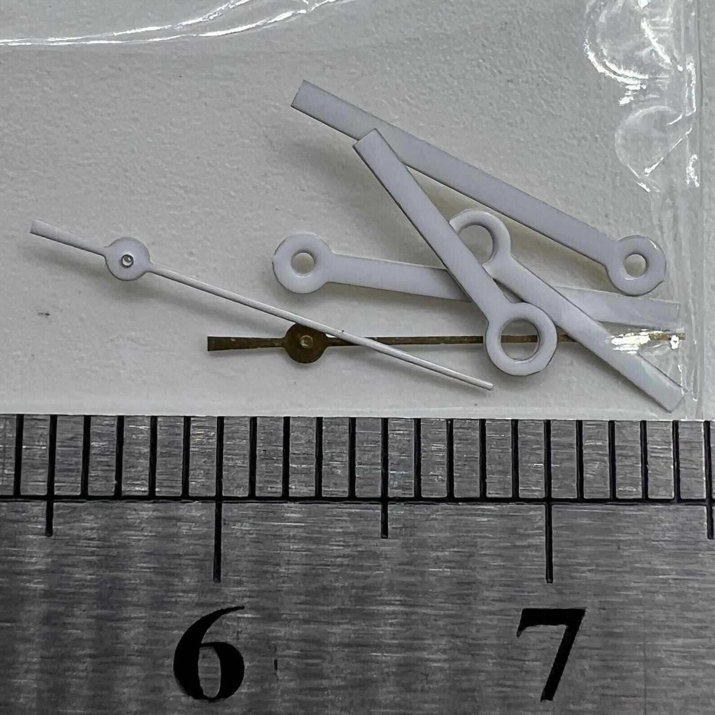 White watch hands set for Miyota 2035 movement, precise fit with 15x13x9mm dimensions, branded quality craftsmanship.