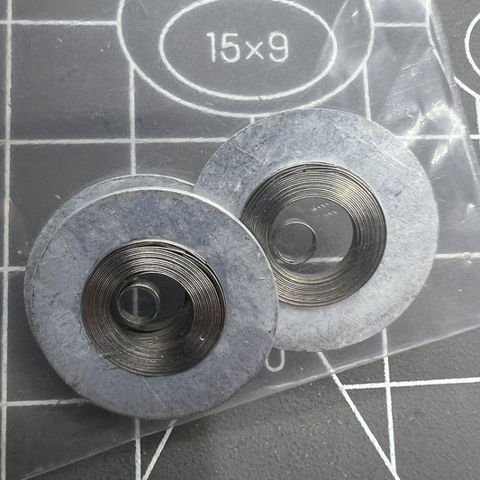 Silver mainspring for Seiko movement 7009#180, durable watch accessory for precise timekeeping.