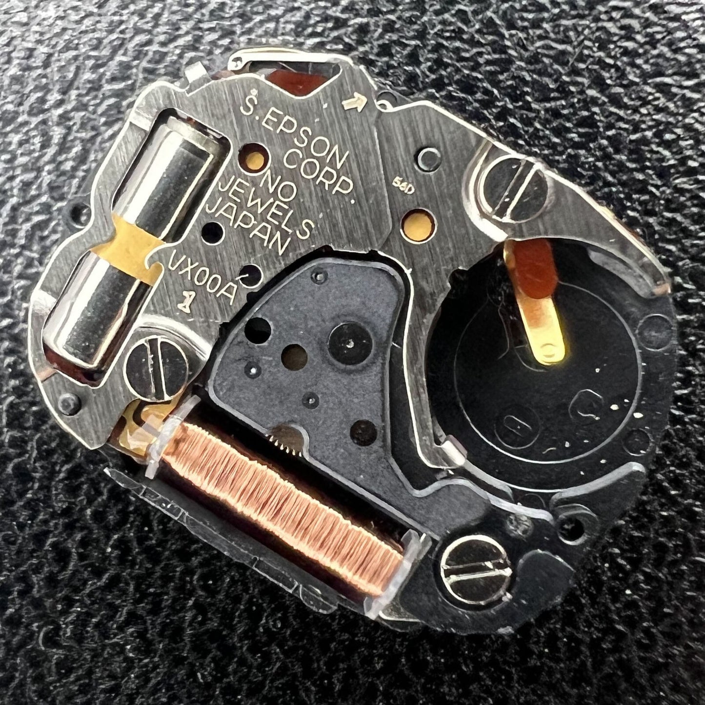 Hattori Epson VX00A quartz watch movement, precise Japan-made component for watch accessory repairs.