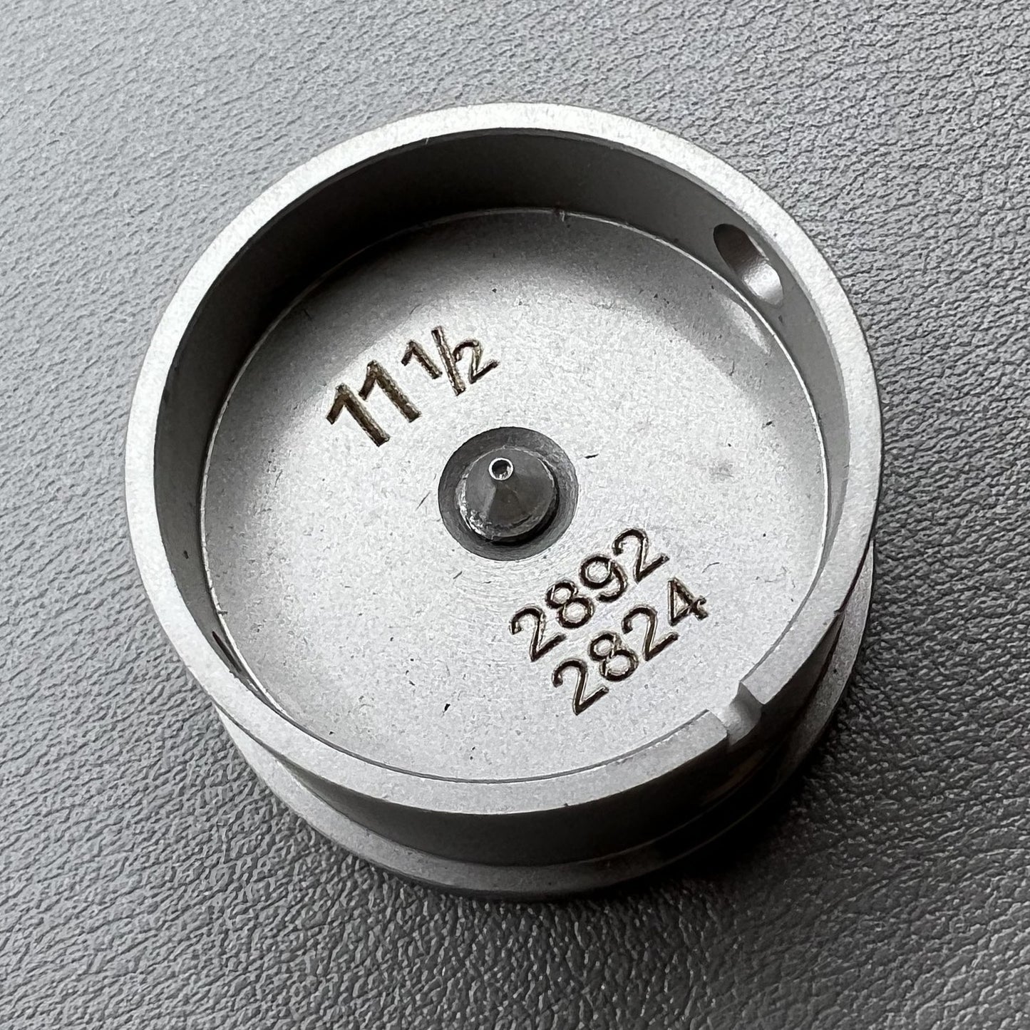 Size 11-1/2 Ligne Eta 2892/2824 movement holder with center screw for watch repair and assembly.