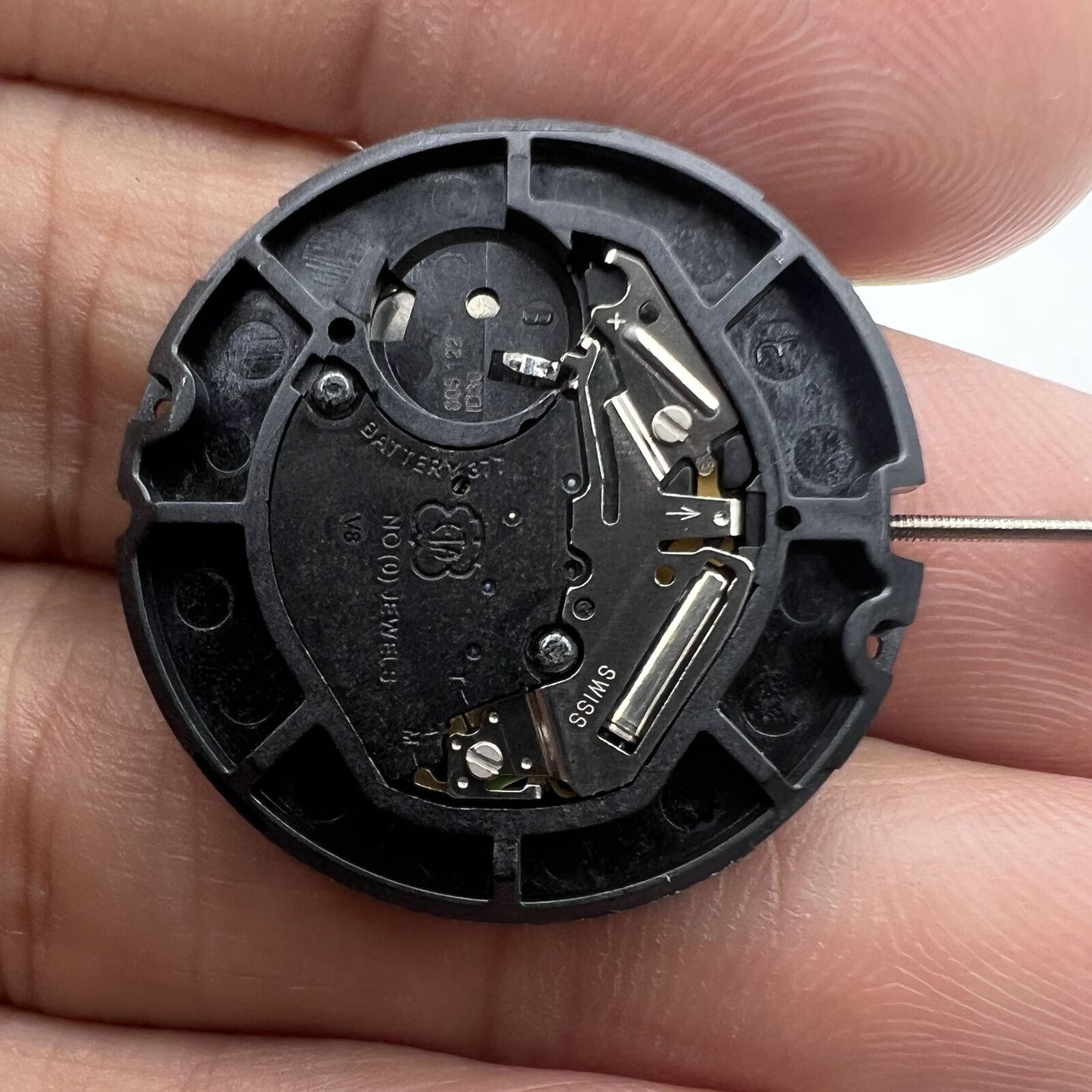 Swiss Made ETA 805.122 quartz watch showing day/date and three hands, featuring precise Swiss movement by ETA.