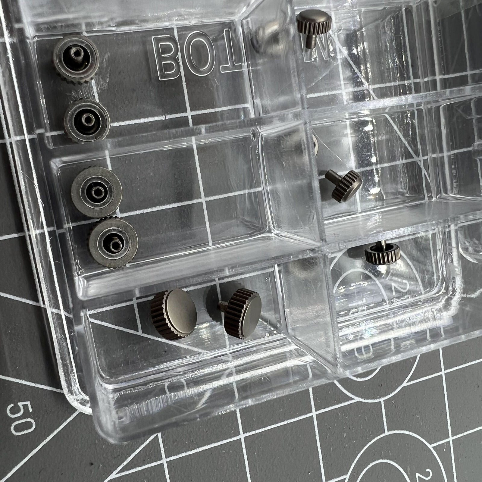 Titanium watch crowns assortment kit, 24 pieces in 12 sizes for precise watch repair.