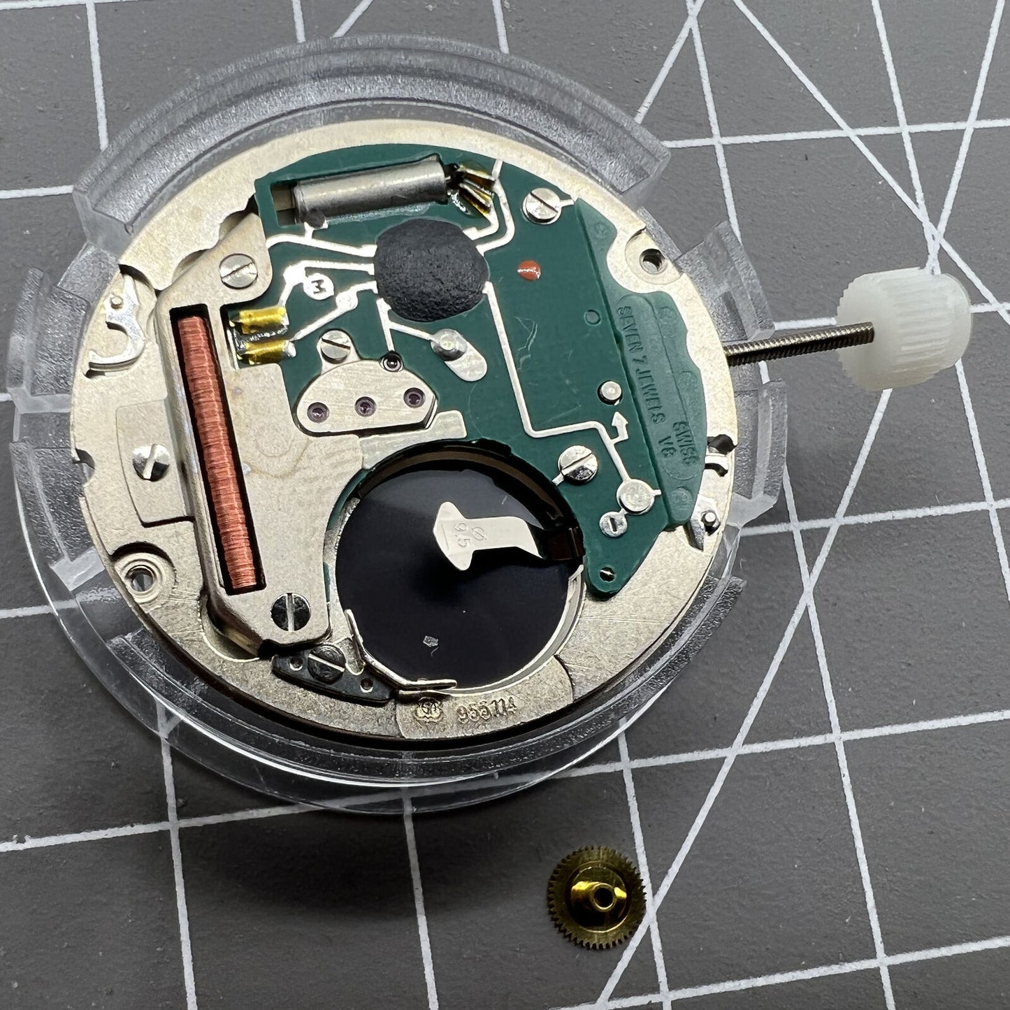 Close-up of Swiss Made ETA955.114 quartz watch movement with single calendar at 3 o?clock for repair.
