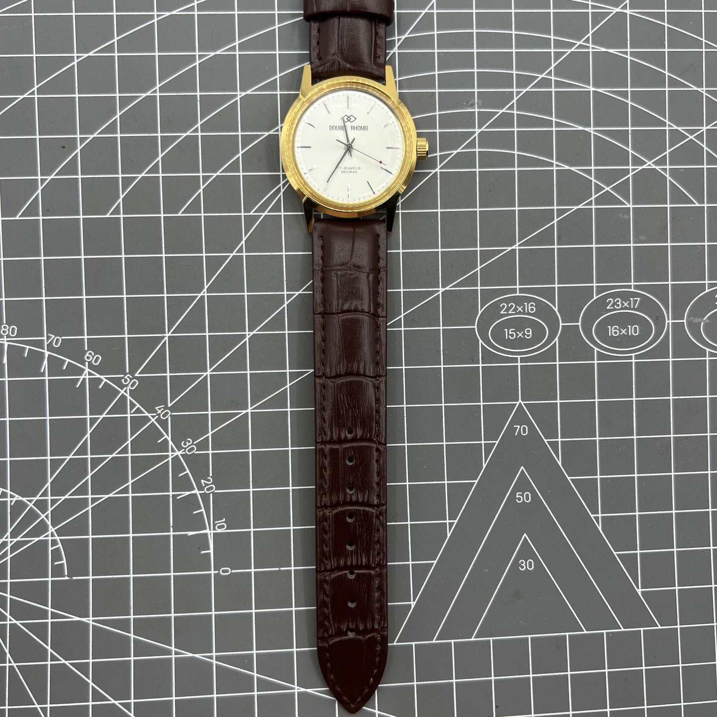 Beijing Double Rhomb manual watch featuring a golden case and silver nail markers, classic style accessory for elegant timekeeping.