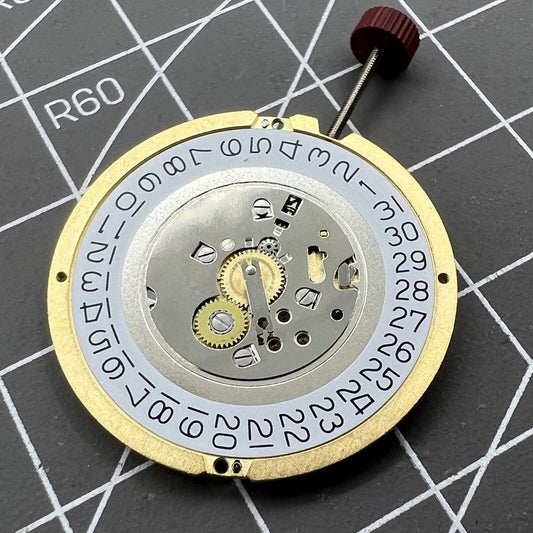 Swiss Made Ronda 1019 quartz watch movement with date display at 3 o'clock, precise timekeeping.