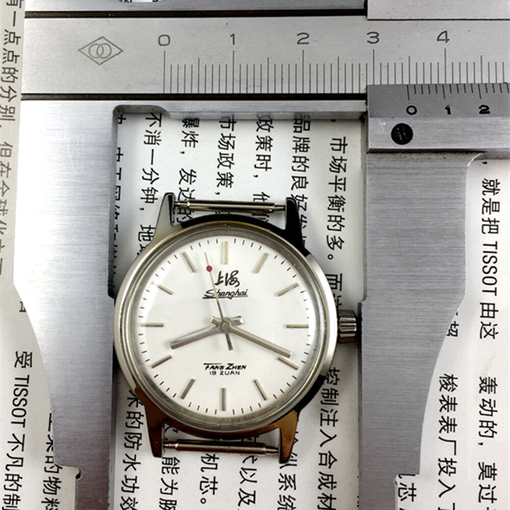 Silver 32mm Shanghai Factory manual watch with silver case, nail markers, and classic mechanical design