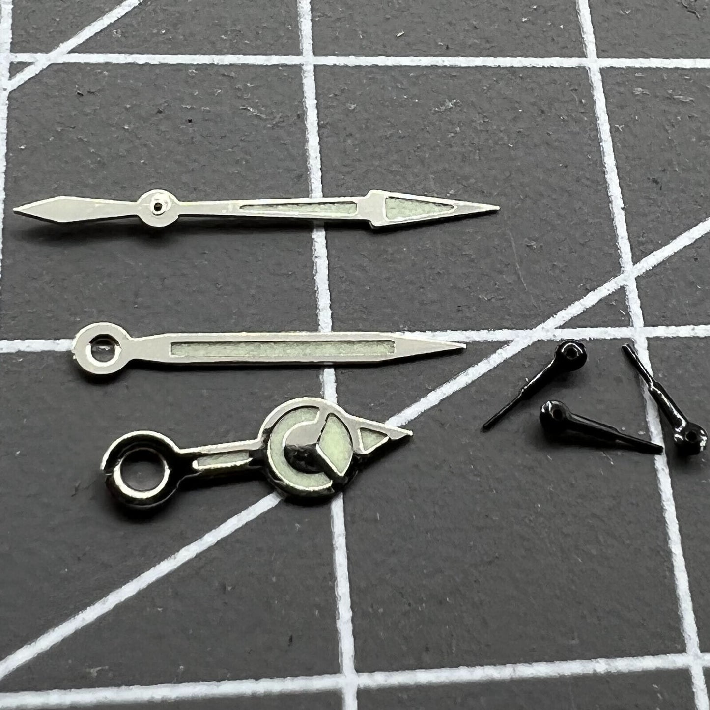 Black 12mm watch hands with silver trim and green luminous finish for Miyota 0S60 movement.