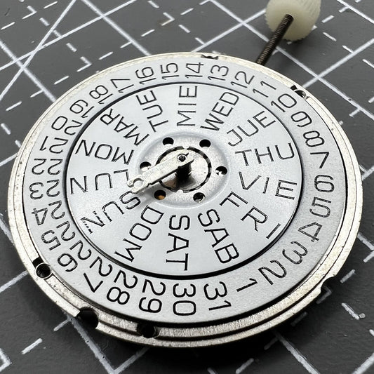 ETA 955.122 quartz watch movement with double calendar and three hands, precision timekeeping.