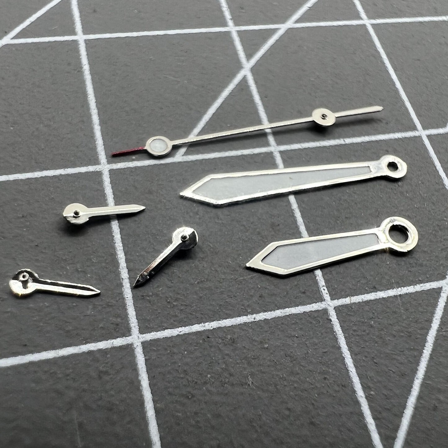 Arrow-shaped 13mm silver-trimmed green lume watch hands for VD53 VD54 VD57 movements, perfect for precise timekeeping.