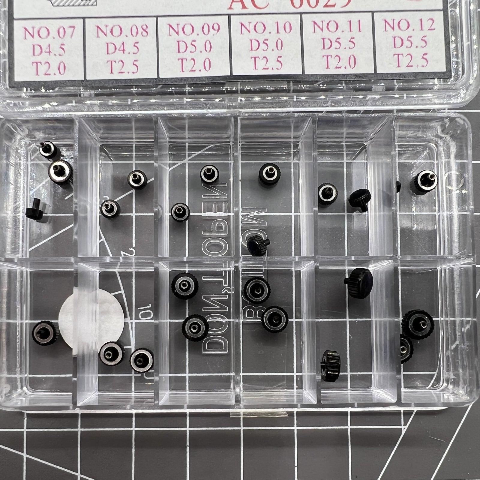 Assortment of 24 black plated stainless steel watch crowns in 12 sizes for repairs.