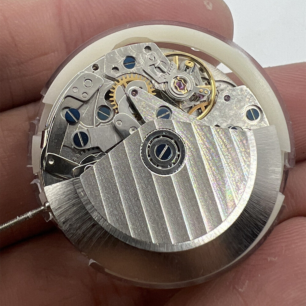 New China SHANGHAI 7750 automatic watch movement displaying day, date, and small seconds at 9 o'clock.