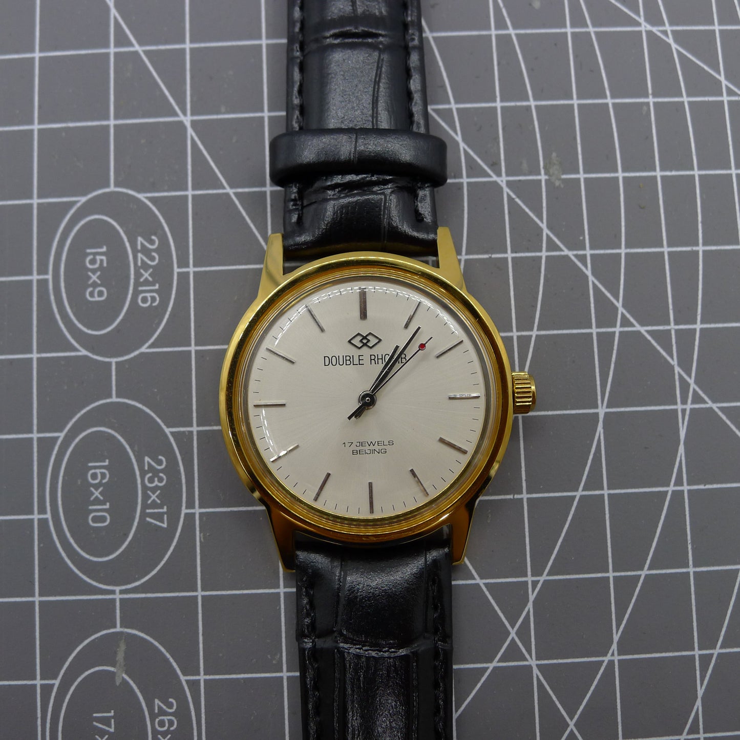 Beijing Double Rhomb mechanical watch with golden case and silver hour markers, elegant classic style.