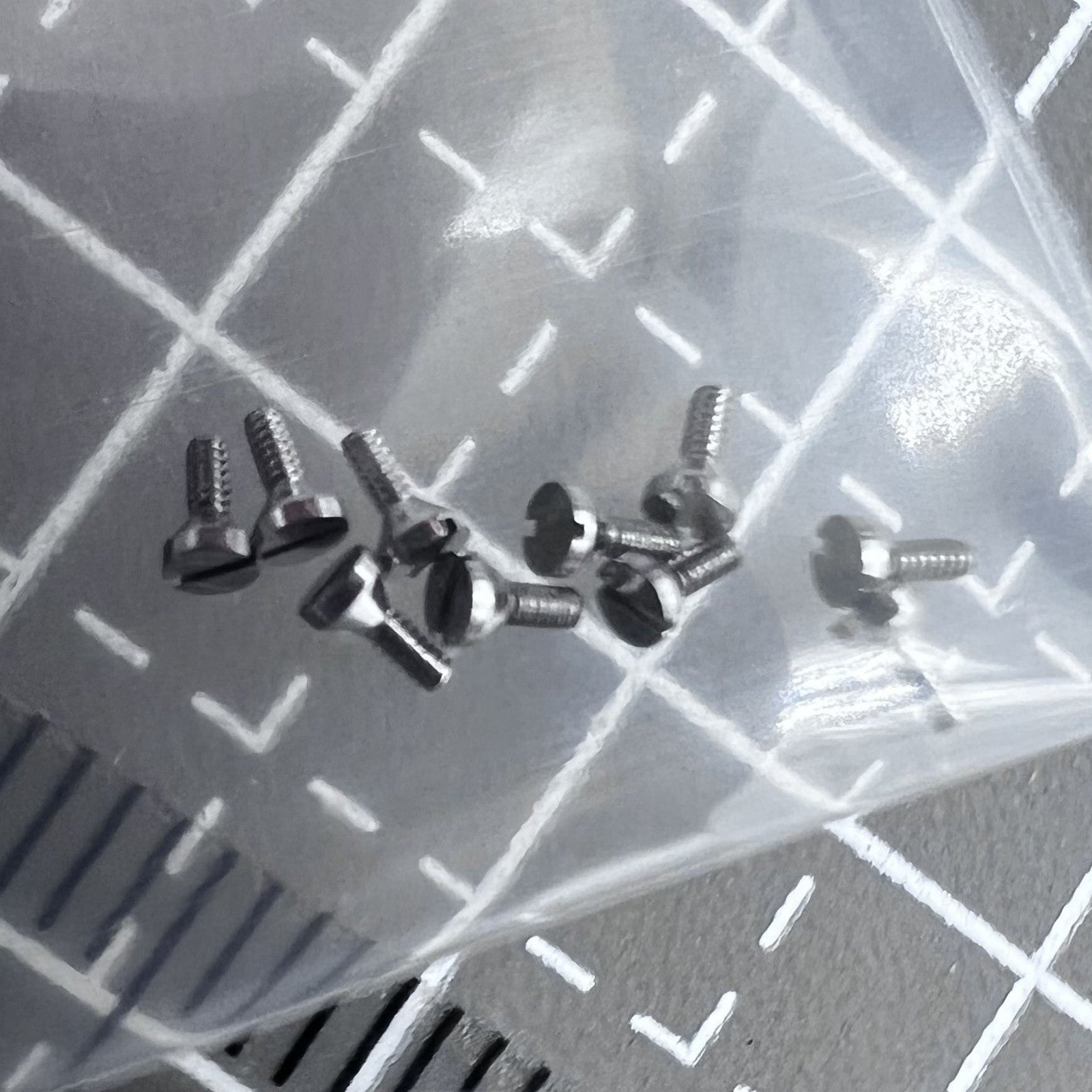 Set of 5 Miyota 8200 dial foot pin screws, durable replacement parts for precise watch assembly.