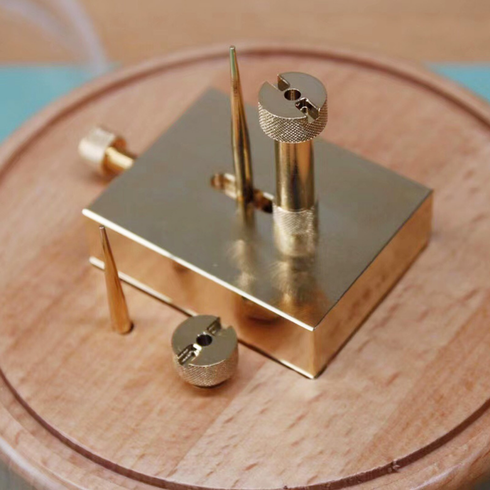 Brass adjustable balance-cock support tool for precise watch movement repairs with dust cover