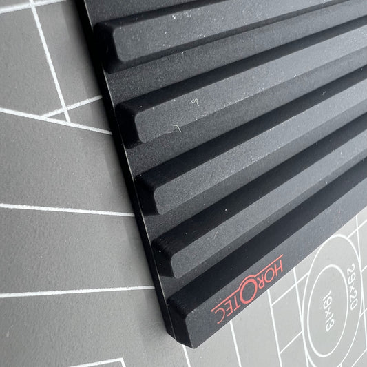 Swiss Horotec MSA24.223 black silicon bench mat with 32 anti-slip grooves for watch repairs and assembly.