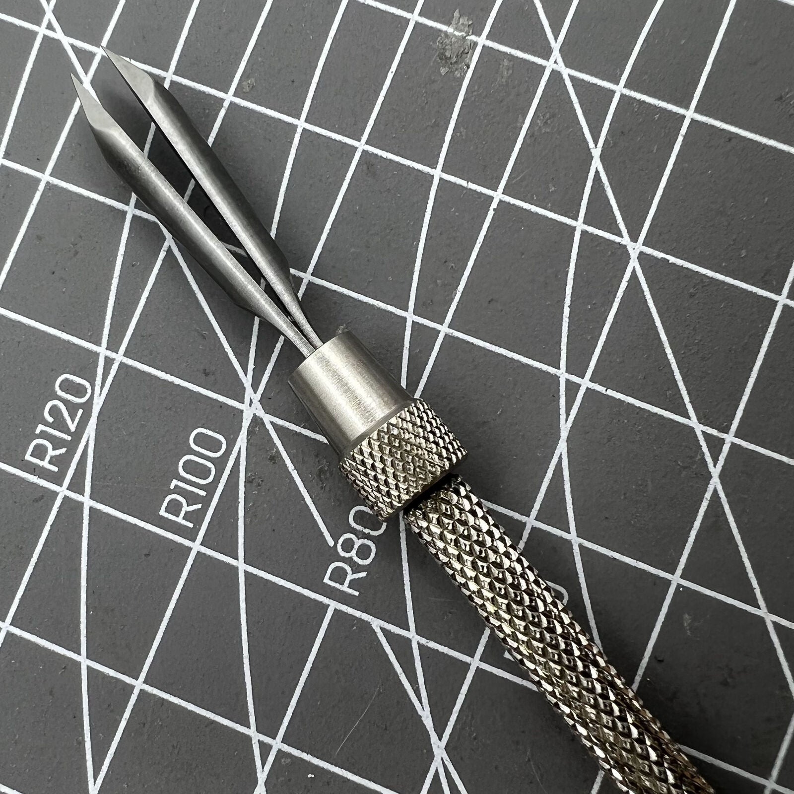 Swiss Bergeon 4072 precision pin vise 105mm securely holding hairsprings for watch repair accuracy.