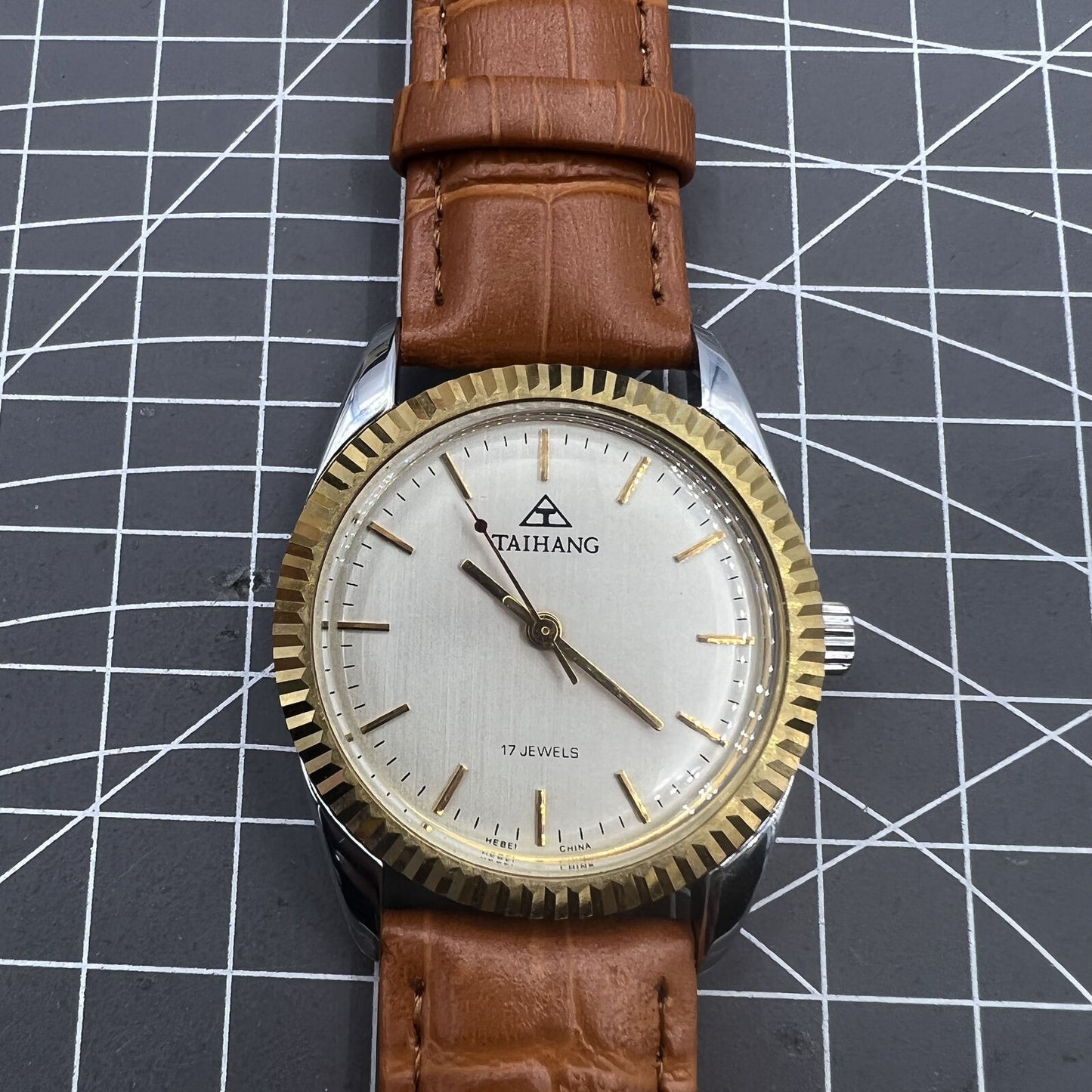 38mm TAIHANG mechanical watch with silver dial, golden markers, round case, and 17 jewel movement.