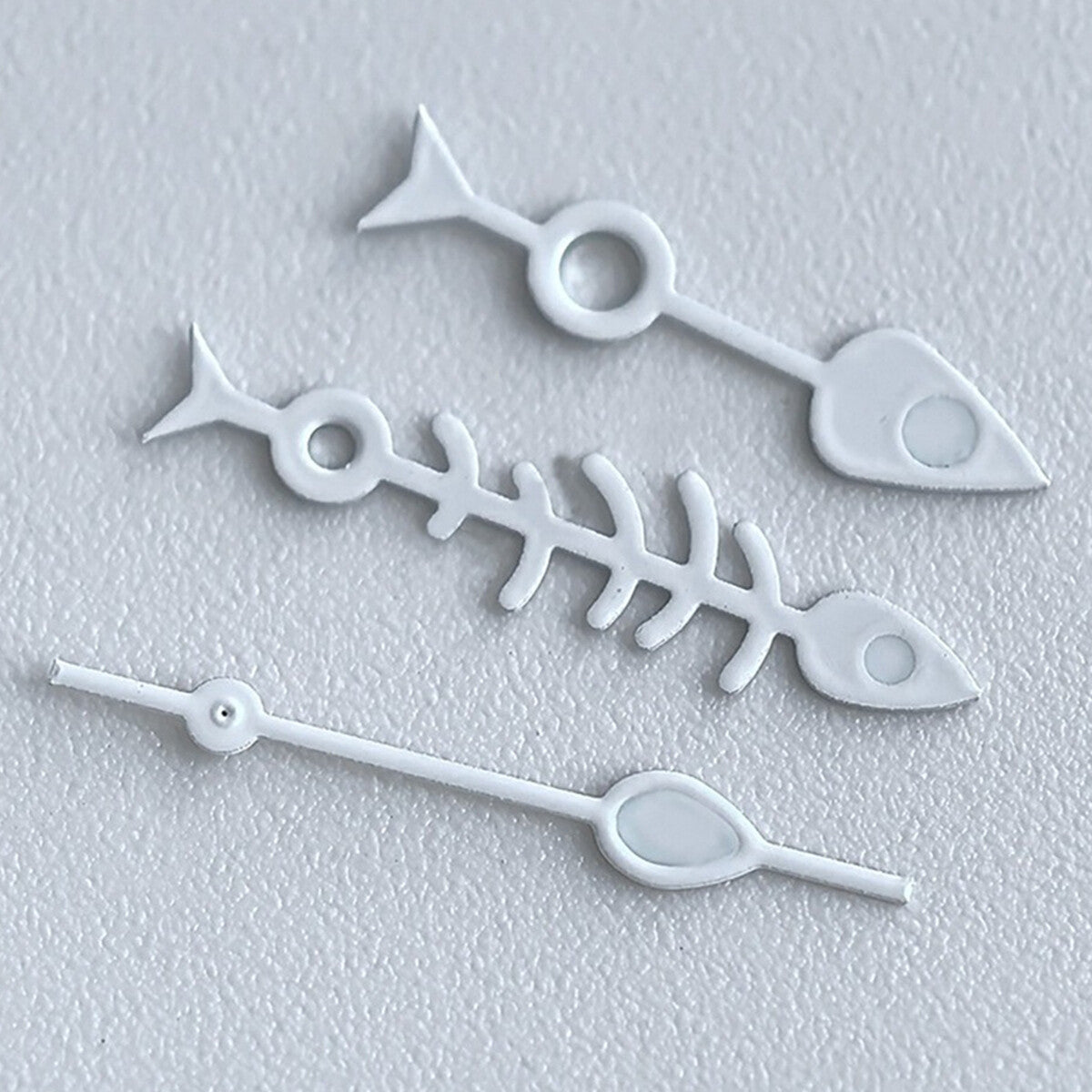 Matted black fish bone watch hands with white trim and green lume, compatible with NH35 NH36.
