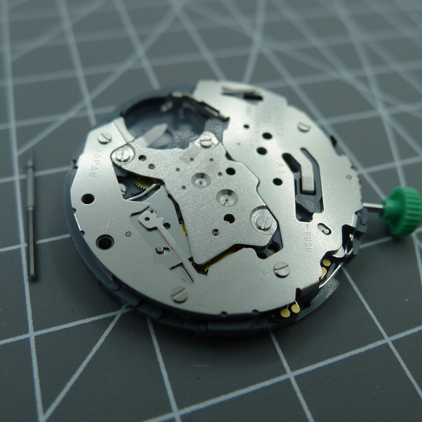 Miyota OS10 quartz watch movement with date display at 3 o'clock, Japanese precision craftsmanship for reliable timekeeping.