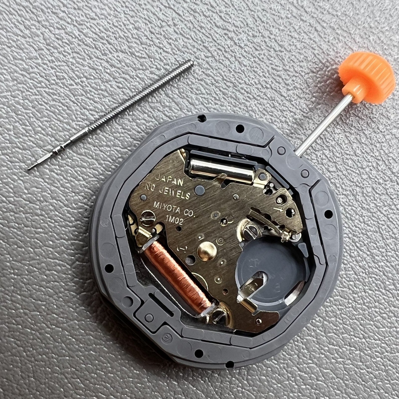 Japan Miyota 1M02 quartz watch movement with three hands and date display at 3 o?clock for accurate timing.