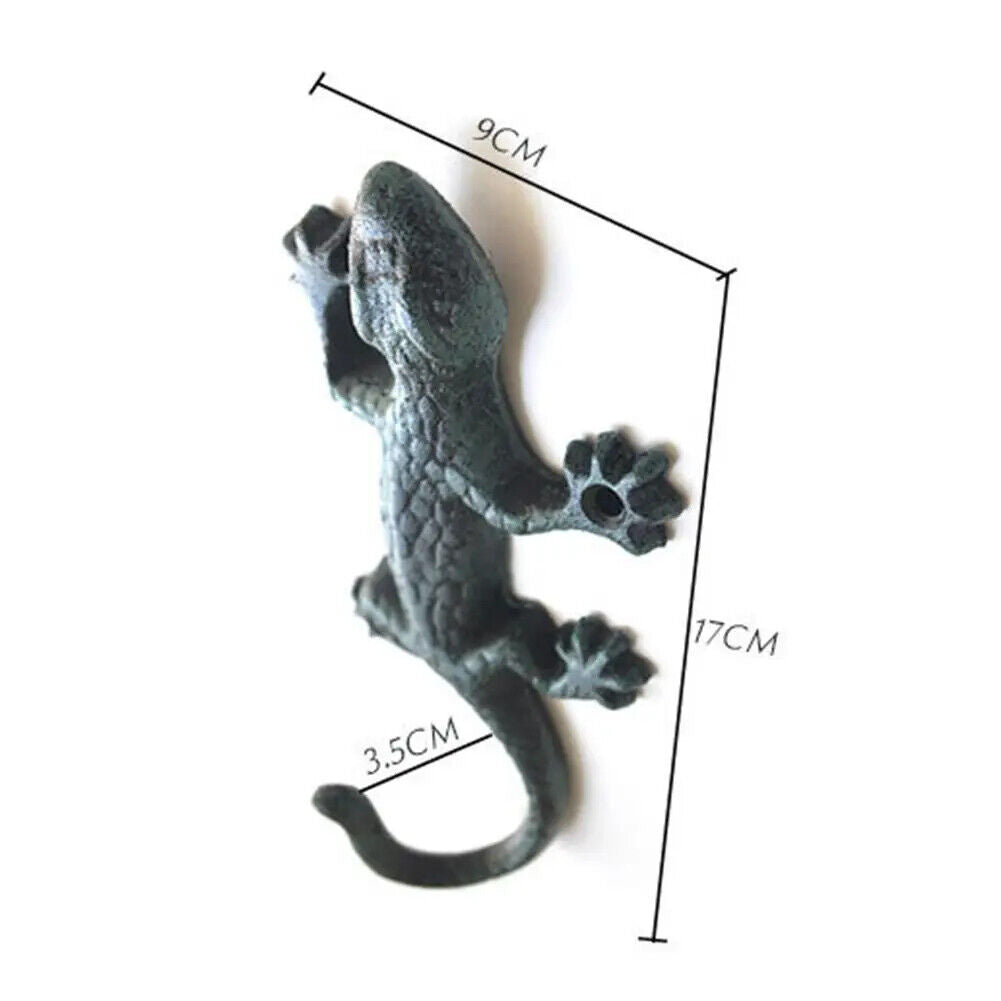 Vintage cast iron gecko wall hook, rustic and durable for hanging cloth or garden tools.