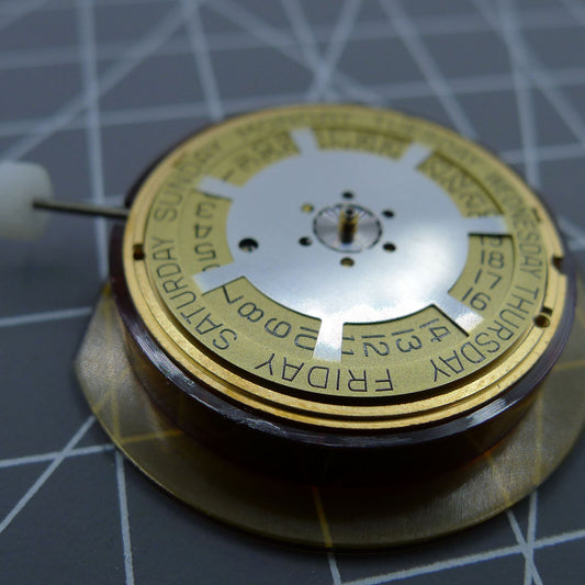 ETA 955.132 quartz watch movement showcasing double calendar with week at 12 and date at 3 position, Swiss made.