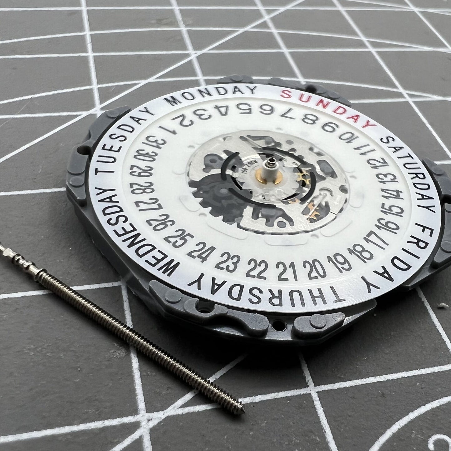 Hattori Epson TMI VJ55 quartz watch movement with date at 6, precision Japan-made component.