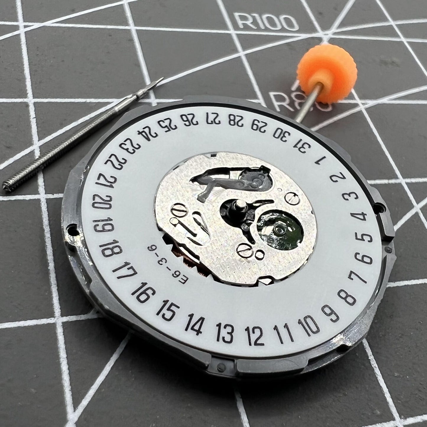 Japan Made Miyota 1M15 quartz watch movement with date at 6 and two hands, precise timekeeping.