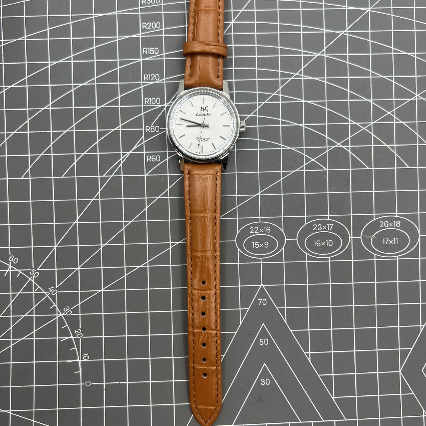 Silver 32mm Shanghai Factory manual mechanical watch with silver case, nail markers, and classic design for watch enthusiasts.