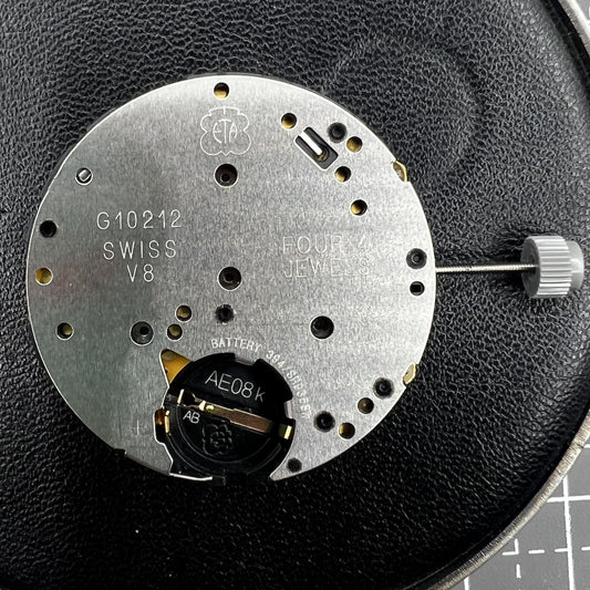 ETA G10.212 quartz watch movement with black disk, three hands, date at 3 o'clock by ETA.