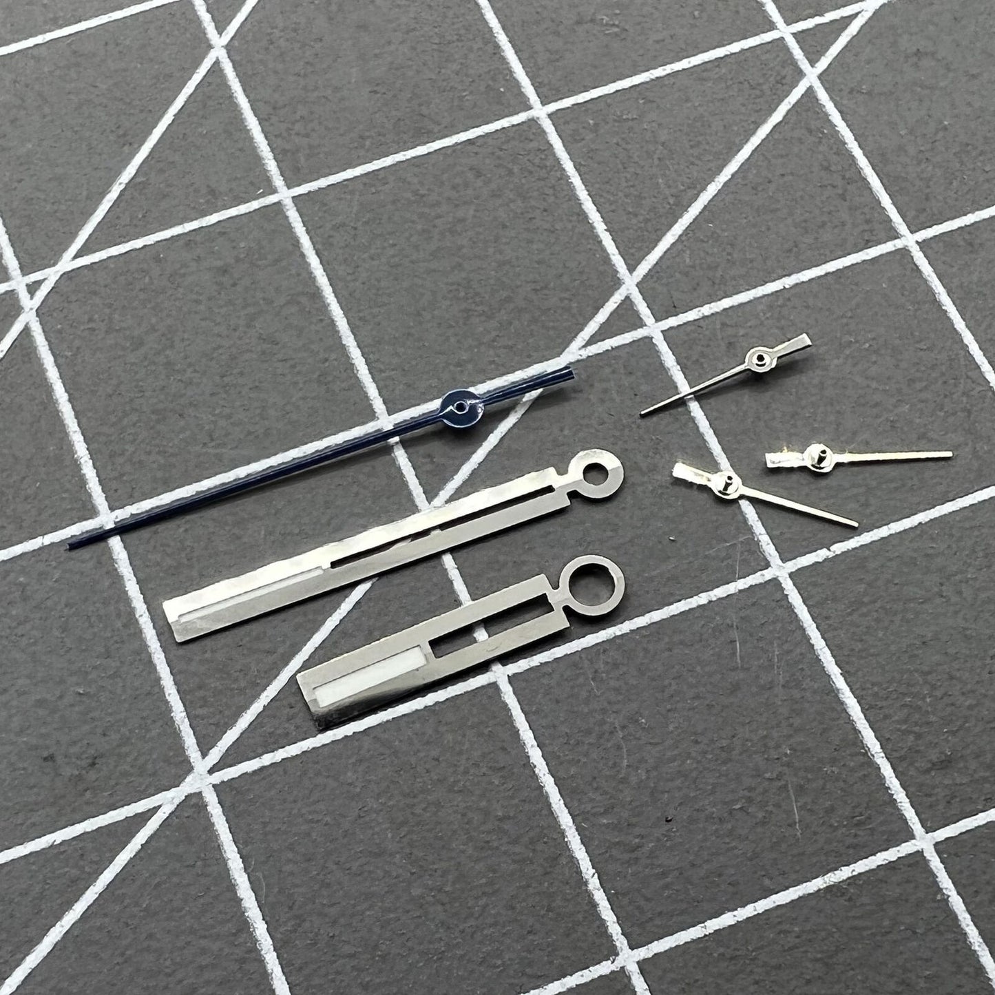 Luminous silver watch hands for Ronda 5021D quartz, perfect for accurate watch repairs and upgrades.