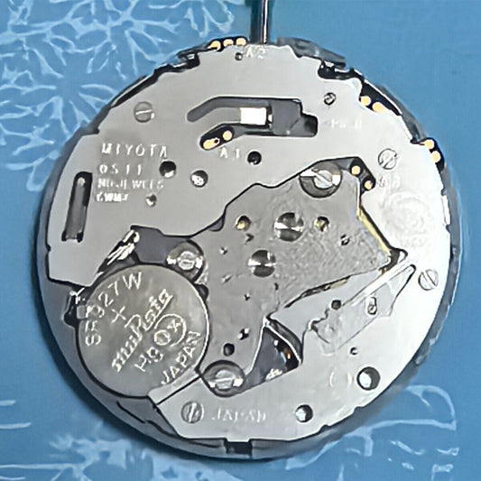 Japan Made Miyota OS11 quartz watch movement with white disk wheel and date at 4 o'clock, precise timekeeping part.