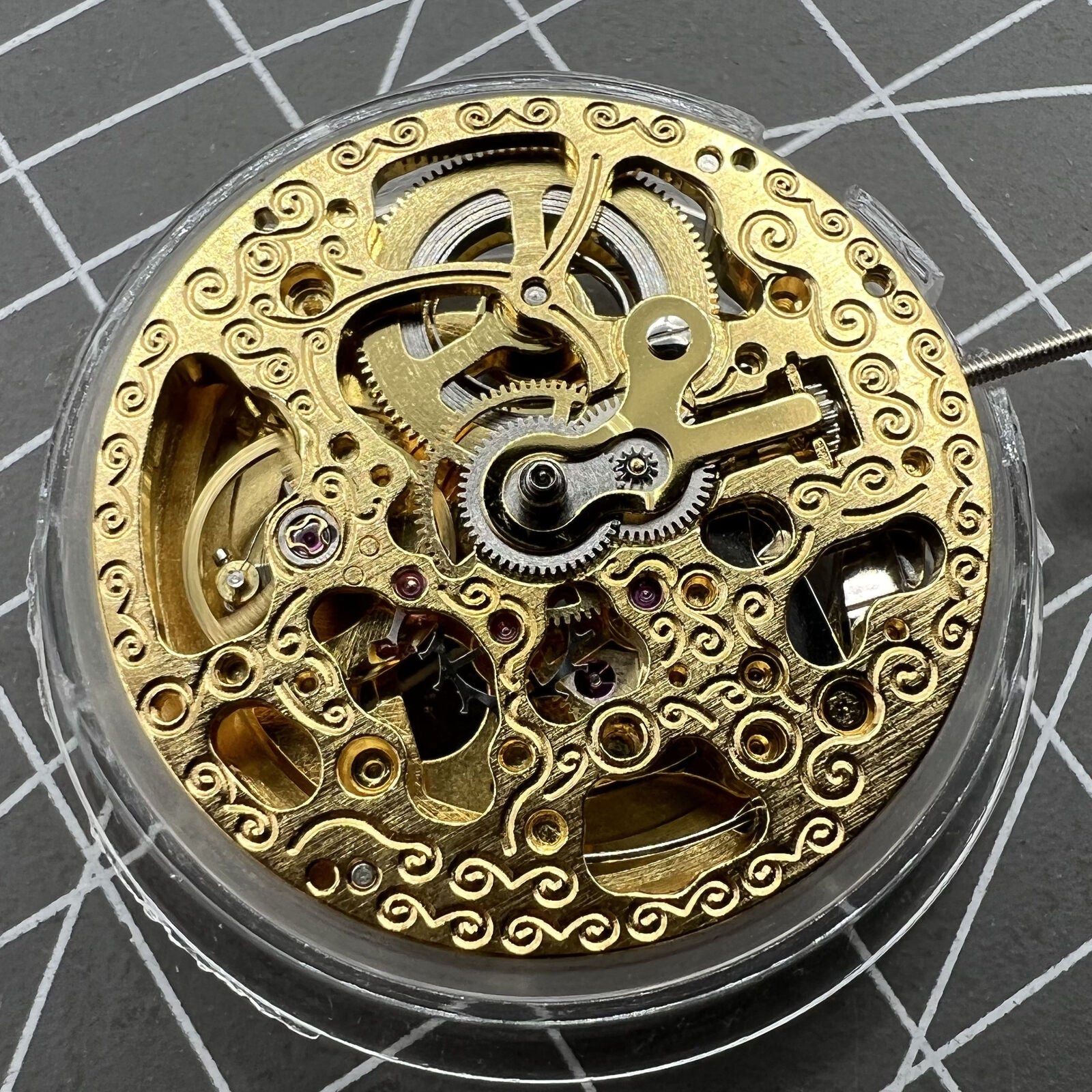 Hangzhou 2189 automatic watch movement with golden 3-hand skeleton design for precise timekeeping.