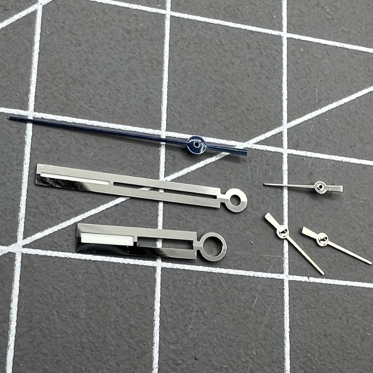 Luminous silver watch hands by Ronda for 5021D quartz movement, perfect for accurate watch repairs.