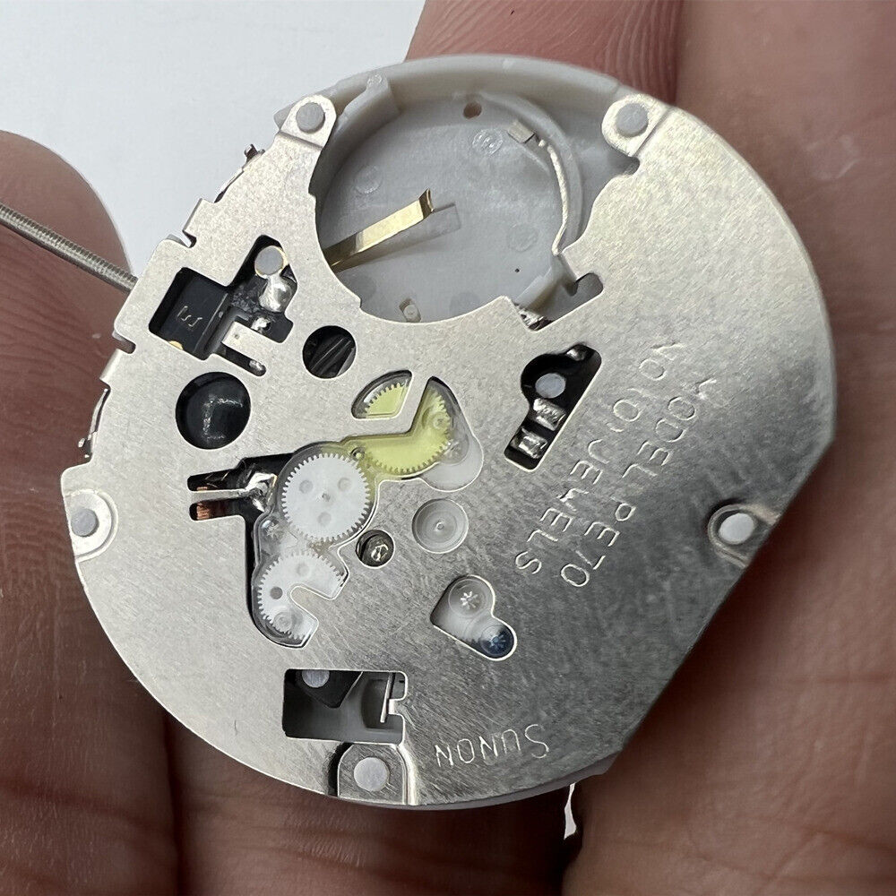 Sunon PE70 quartz watch movement with 3 hands, dual date display, and 3 subdials for precision timekeeping.