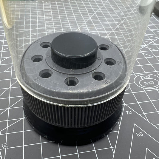 Grey rotated screwdriver holder with transparent cover, organizing 9 screwdrivers efficiently.