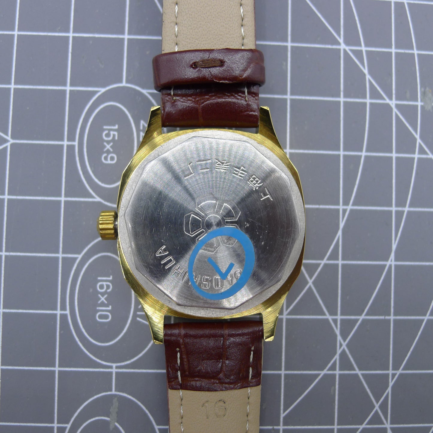 Shanghai brand 33mm manual mechanical watch with blue dial, golden nail markers, square case, and 17 jewels movement.