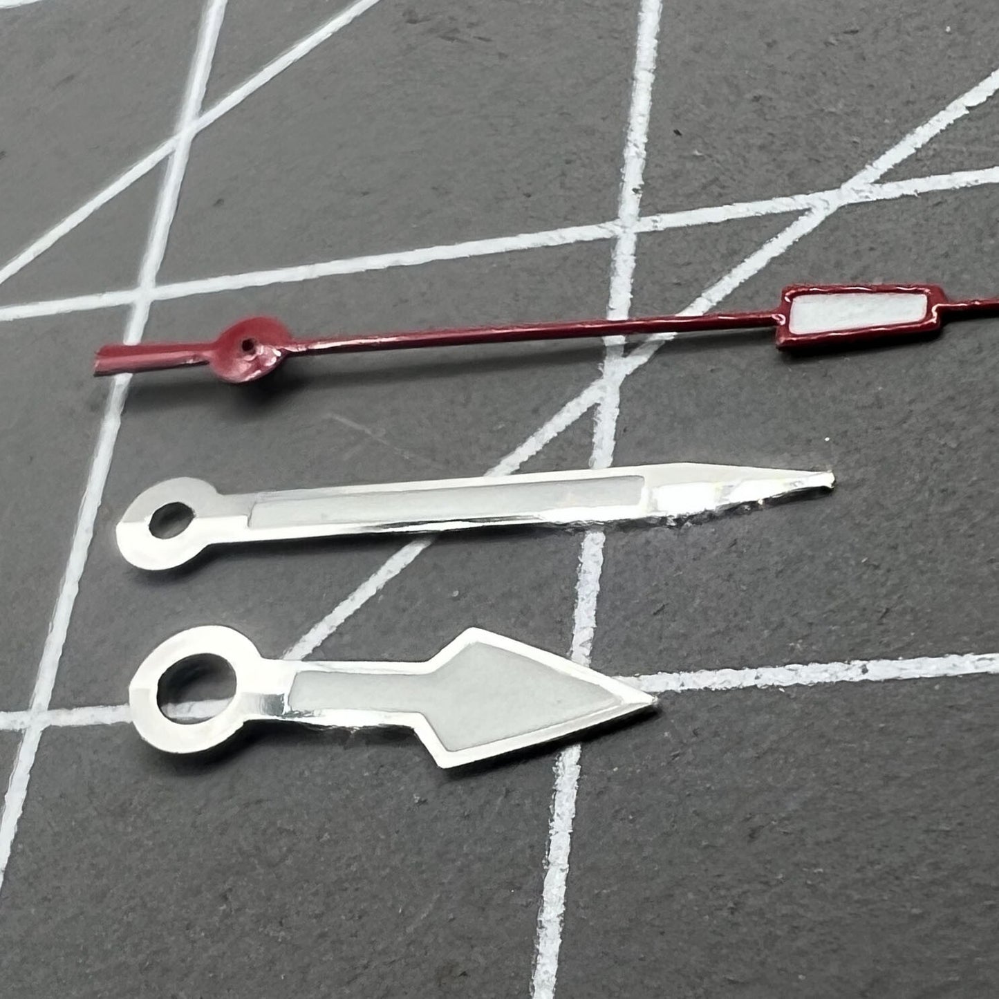 Silver arrow-shaped watch hands with red second hand and green lume, compatible with NH35 NH36 movements, for precise timekeeping.