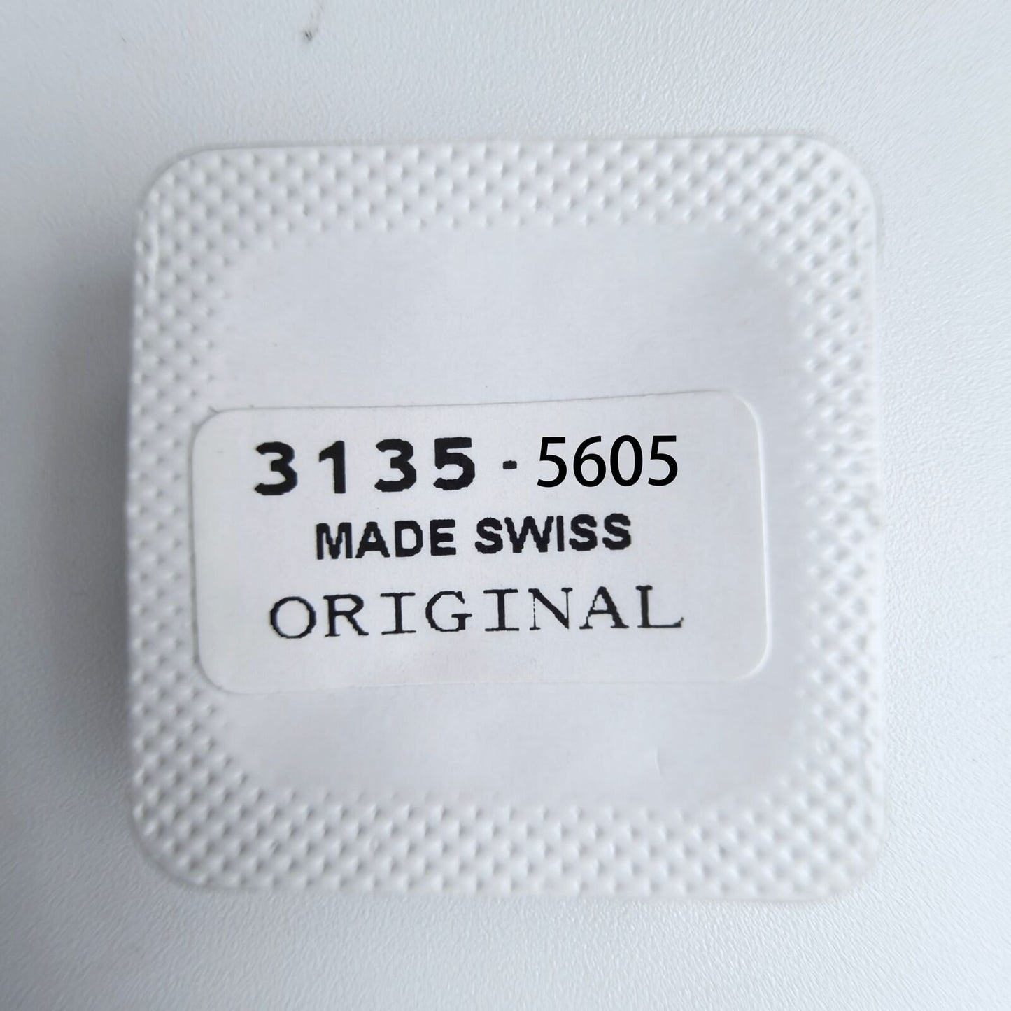 1. Close-up of Replacements 3135-5605 date indicator driving wheel screws for 3135 watch movement by Rolex.