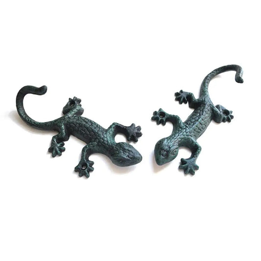 Vintage cast iron gecko wall hook for hanging clothes and garden tools.