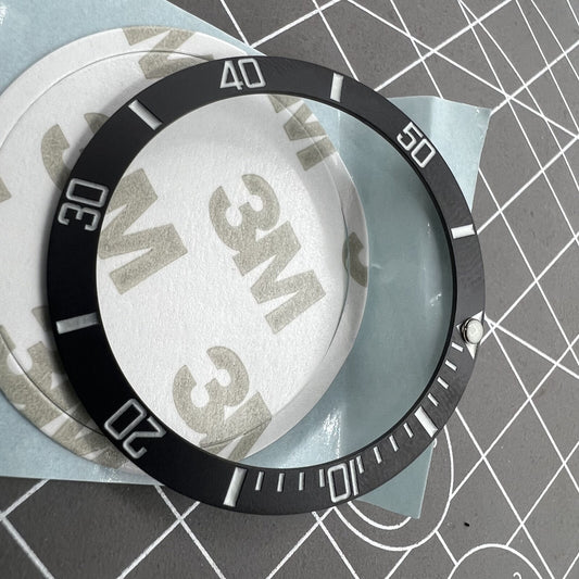 38mm ceramic watch bezel with black slope, silver font, and blue luminous details for watch accessories.