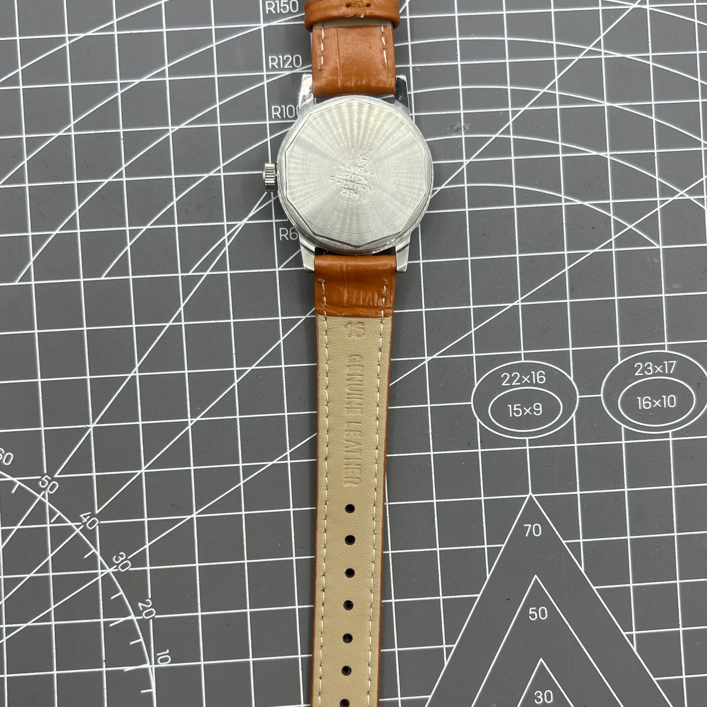 Silver 32mm Shanghai Factory manual watch with silver case and nail markers, classic mechanical design.