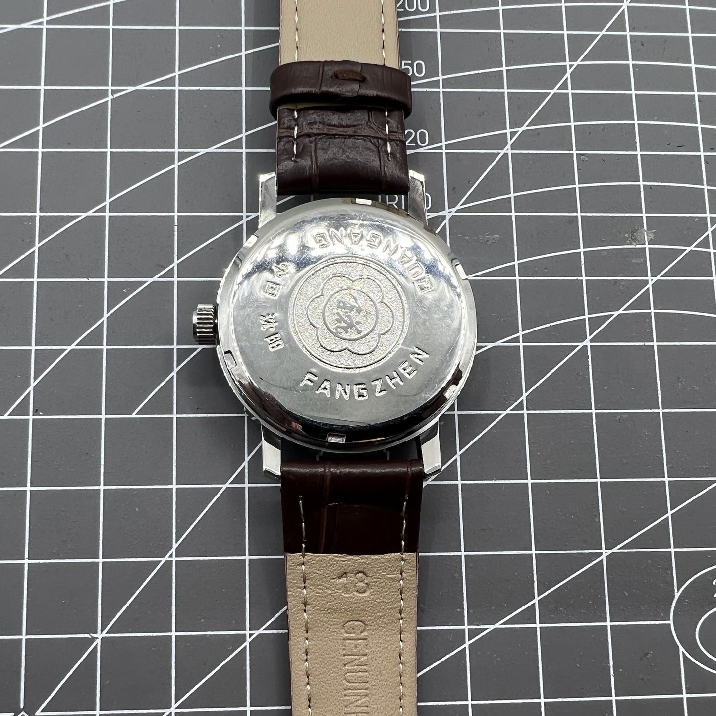 China Baihua 37mm manual mechanical watch with silver dial, 19 jewels, shock-resistant for durable wear.