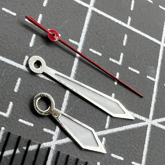 Pair of 12mm green lume arrow-shaped watch hands for Miyota 1M12 movement, glowing clarity.