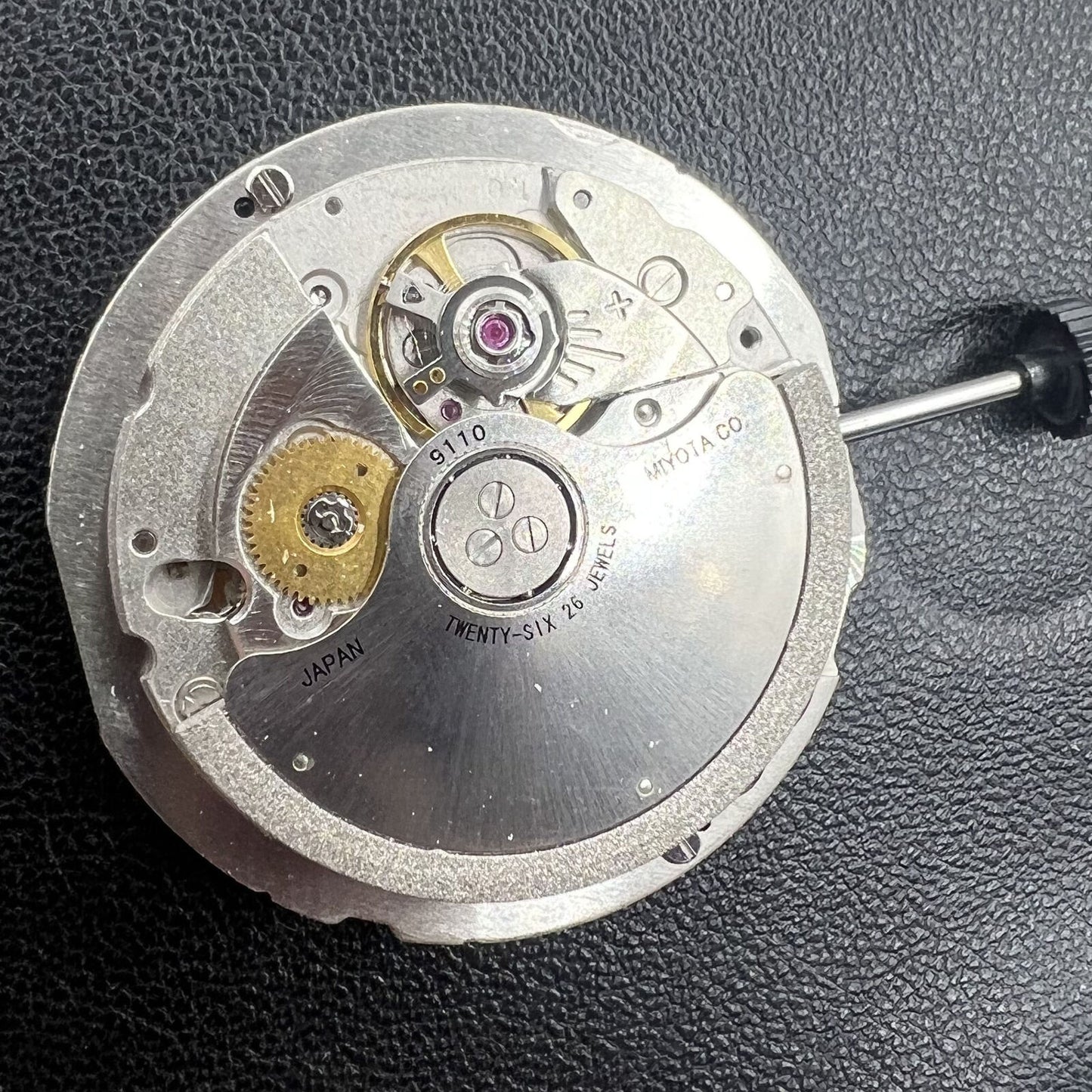 Miyota 9110 automatic watch movement showing date at 3 o'clock, precision mechanical craftsmanship.