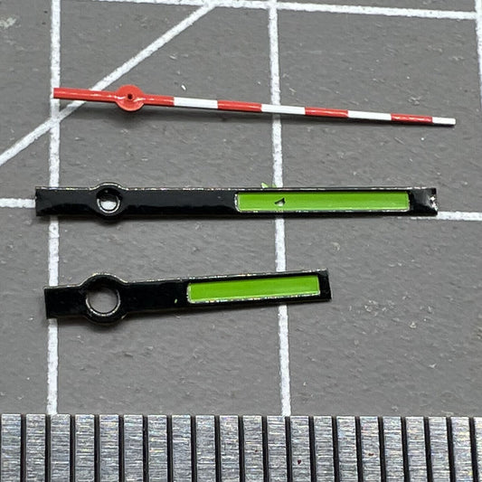 Black, red, and white trimmed green watch hands for Ronda 515 quartz, perfect for precise timekeeping.