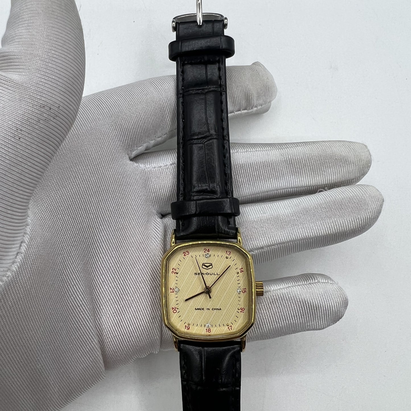 Seagull 28mm ladies watch with golden square case, manual mechanical movement, and elegant design for stylish wear.
